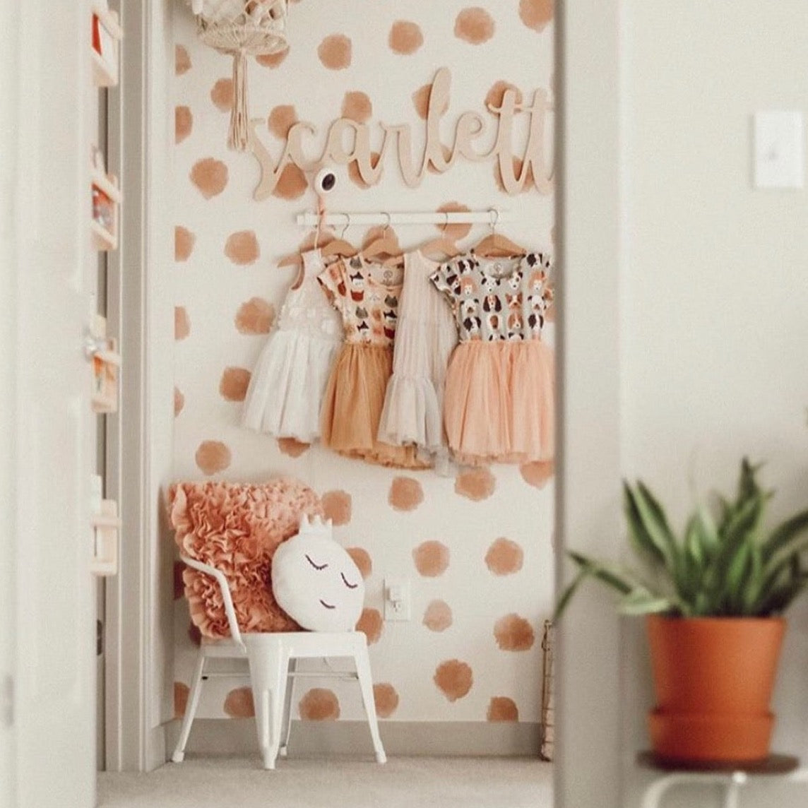 Joyce polka dot wallpaper in terracotta and cream for a minimalist bohemian aesthetic.