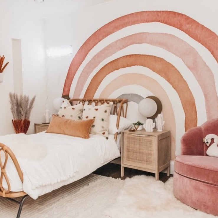 Rae geometric wallpaper featuring terracotta, sage-green, and cream patterns in a bohemian scandi-kids nursery.