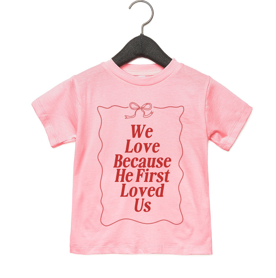 Minimalist kids tee with 'We Love Because He First Loved Us' text