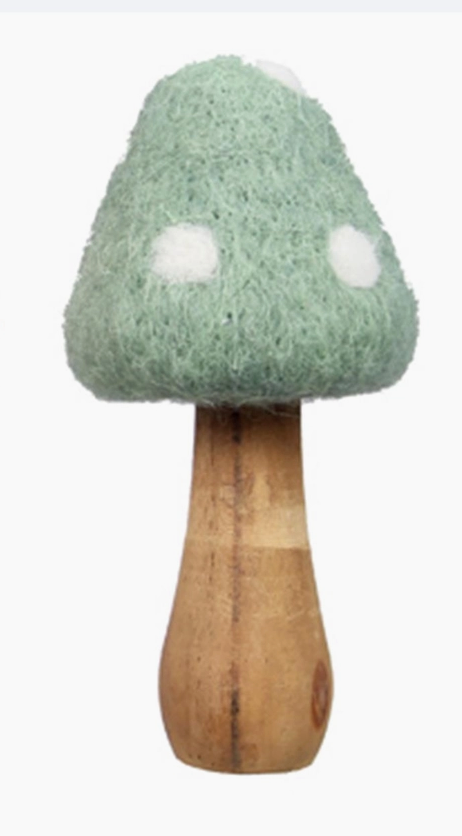 A close-up view of a green wool-capped mushroom with a wooden stem, part of a three-piece tabletop decor set.