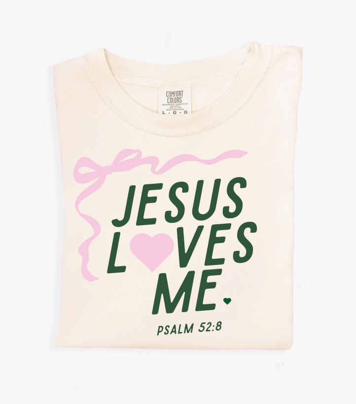 Unisex 'Jesus Loves Me' ribbon graphic tee in multiple colors like cream, black, and forest-green.