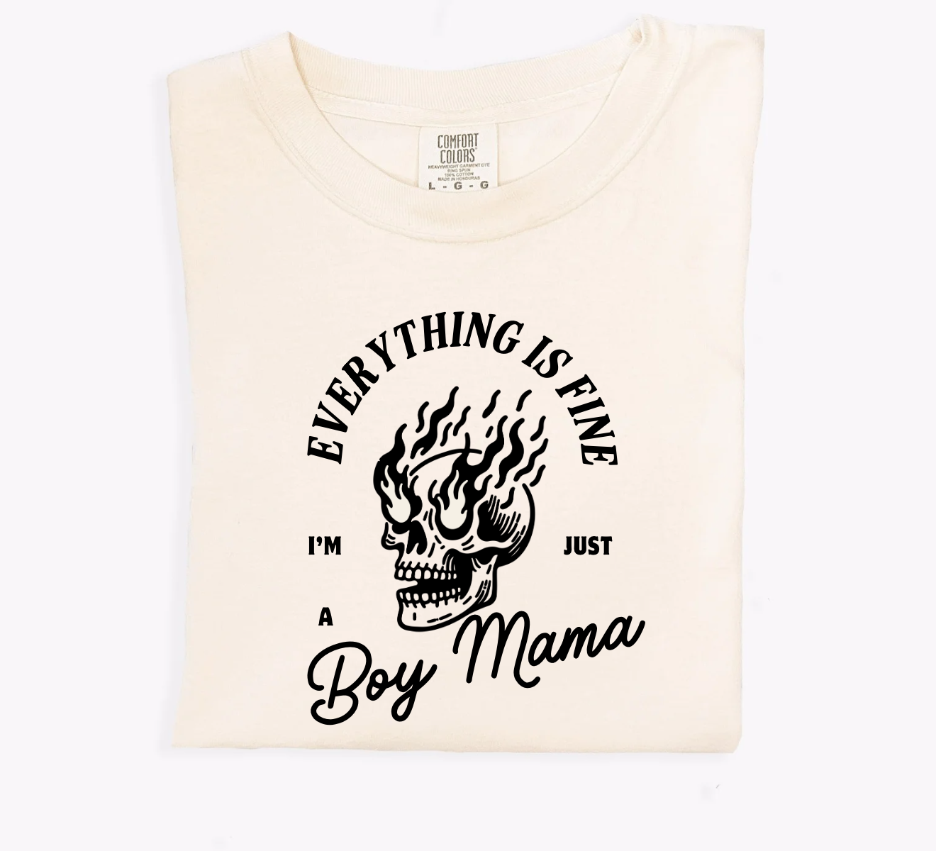 A cream-colored graphic t-shirt with the text Everything's Fine, I'm Just a Boy Mama Tee.