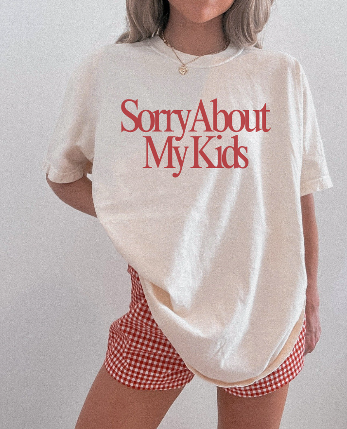 Women's Sorry About My Kids graphic t-shirt in cream with red lettering