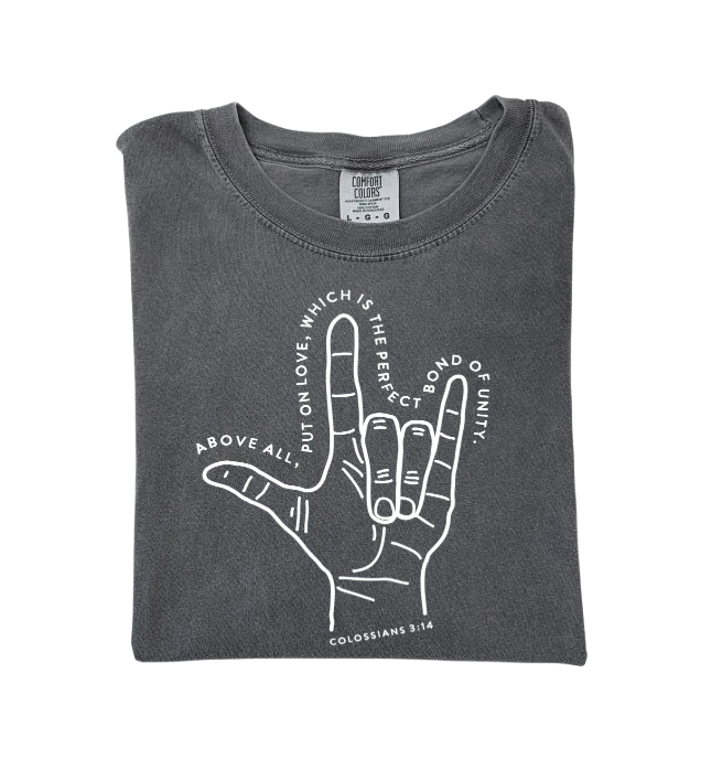 A charcoal grey Colossians 3:14 graphic t-shirt laid flat, minimal design.