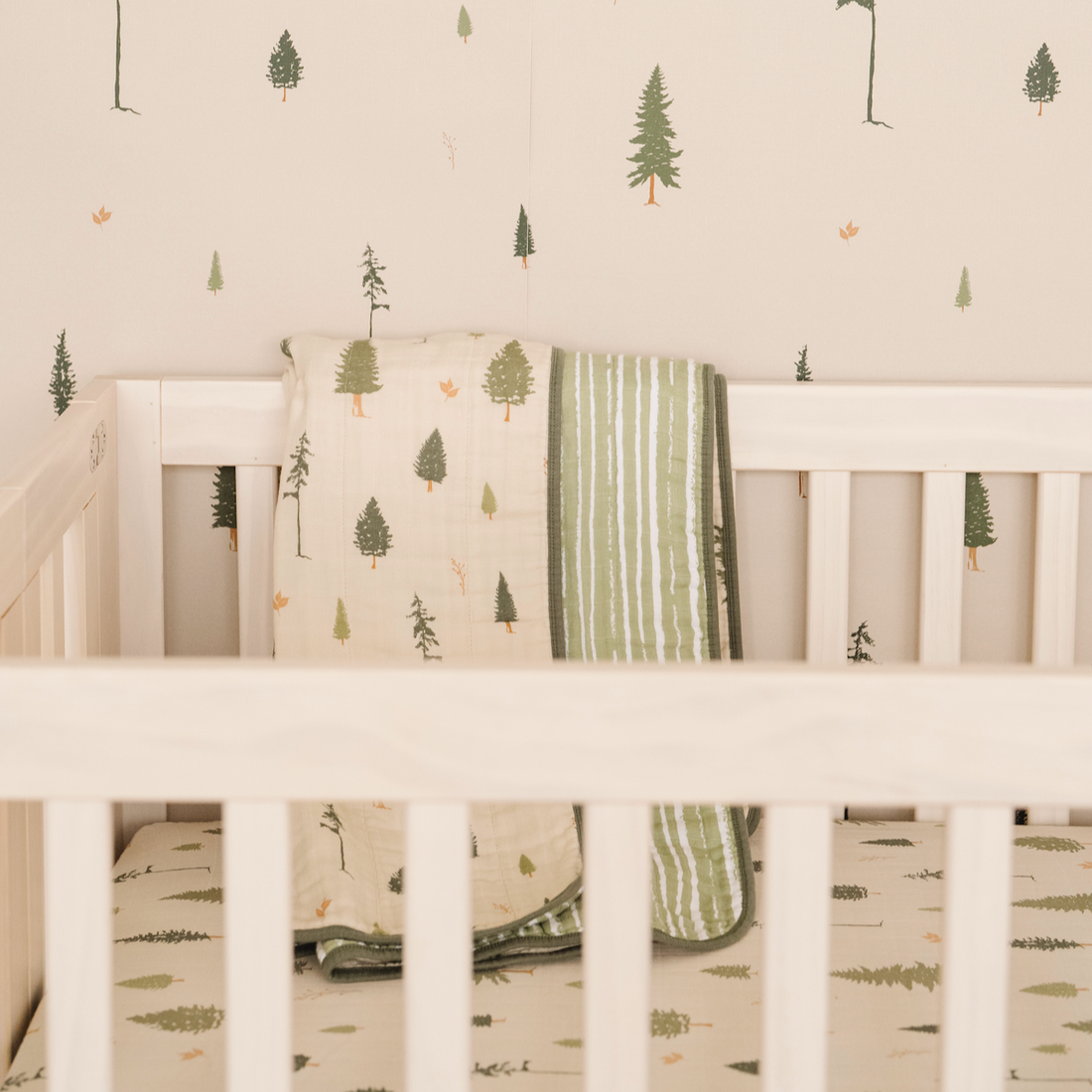 Pine nature-inspired wallpaper featuring a calming green and beige design suitable for nurseries.