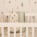 Pine nature-inspired wallpaper featuring a calming green and beige design suitable for nurseries.