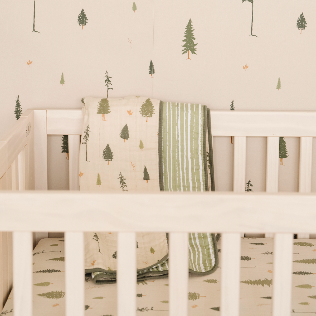 Pine nature-inspired wallpaper featuring a calming green and beige design suitable for nurseries.