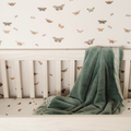 Whimsical butterfly wallpaper in muted-pink, sage-green, and gold on an off-white background.