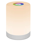 A portable touch-dimmable LED table lamp sitting on a modern bedside table