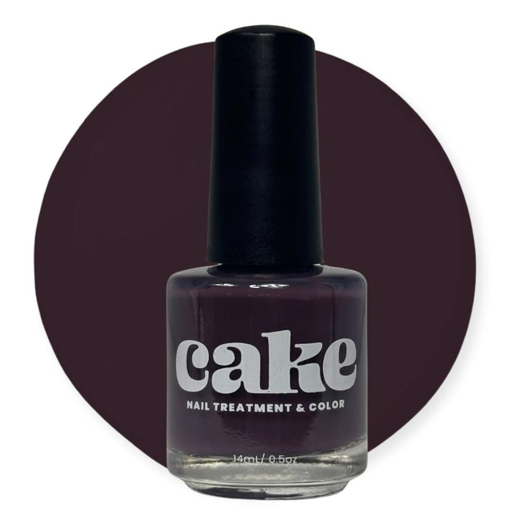 Bottle of CAKE Nail Strengthening Polish in deep plum shade Plum & Circumstance