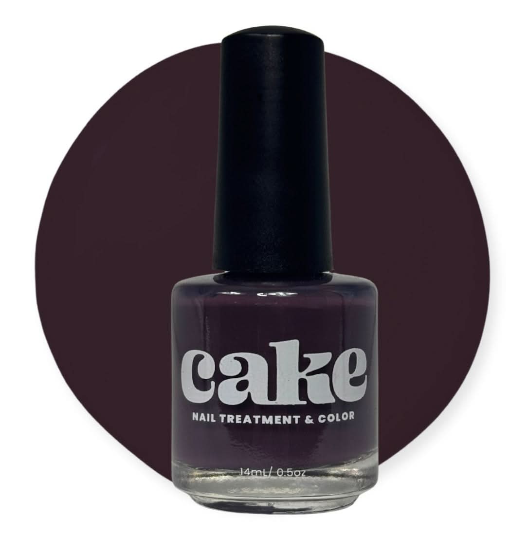 Bottle of CAKE Nail Strengthening Polish in deep plum shade Plum & Circumstance