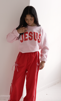 Unisex sweatshirt with Jesus varsity lettering in a casual streetwear style.