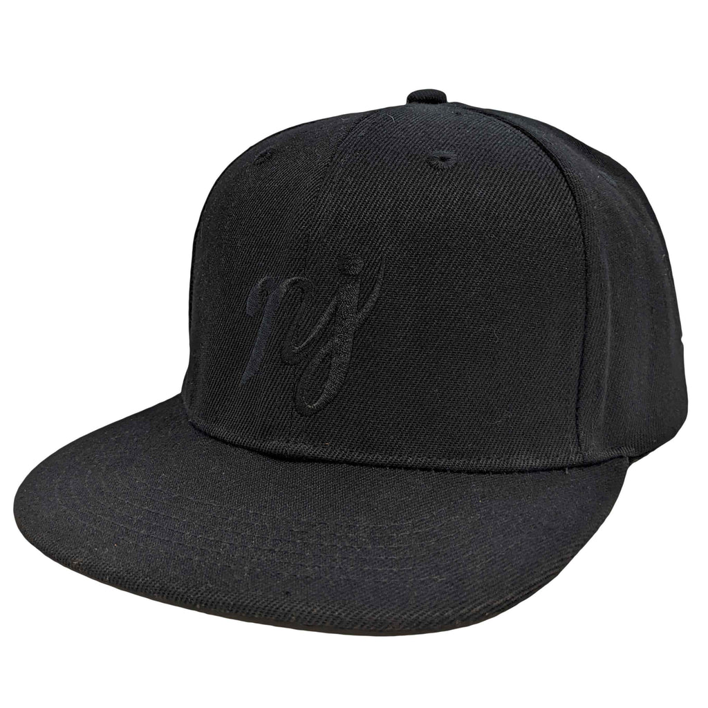 A solid black snapback hat with white NJ scripture embroidery, photographed on a neutral background.