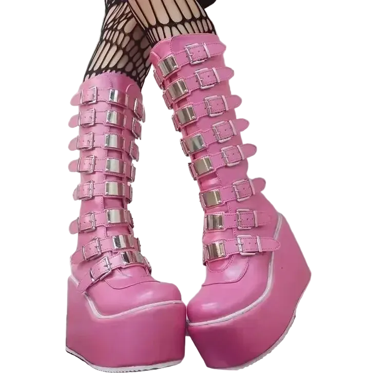 A pair of platform wedge boots with multiple silver buckle straps against a white background.