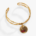 Hammered metal twisted cuff bracelet featuring detailed coral and crab charms