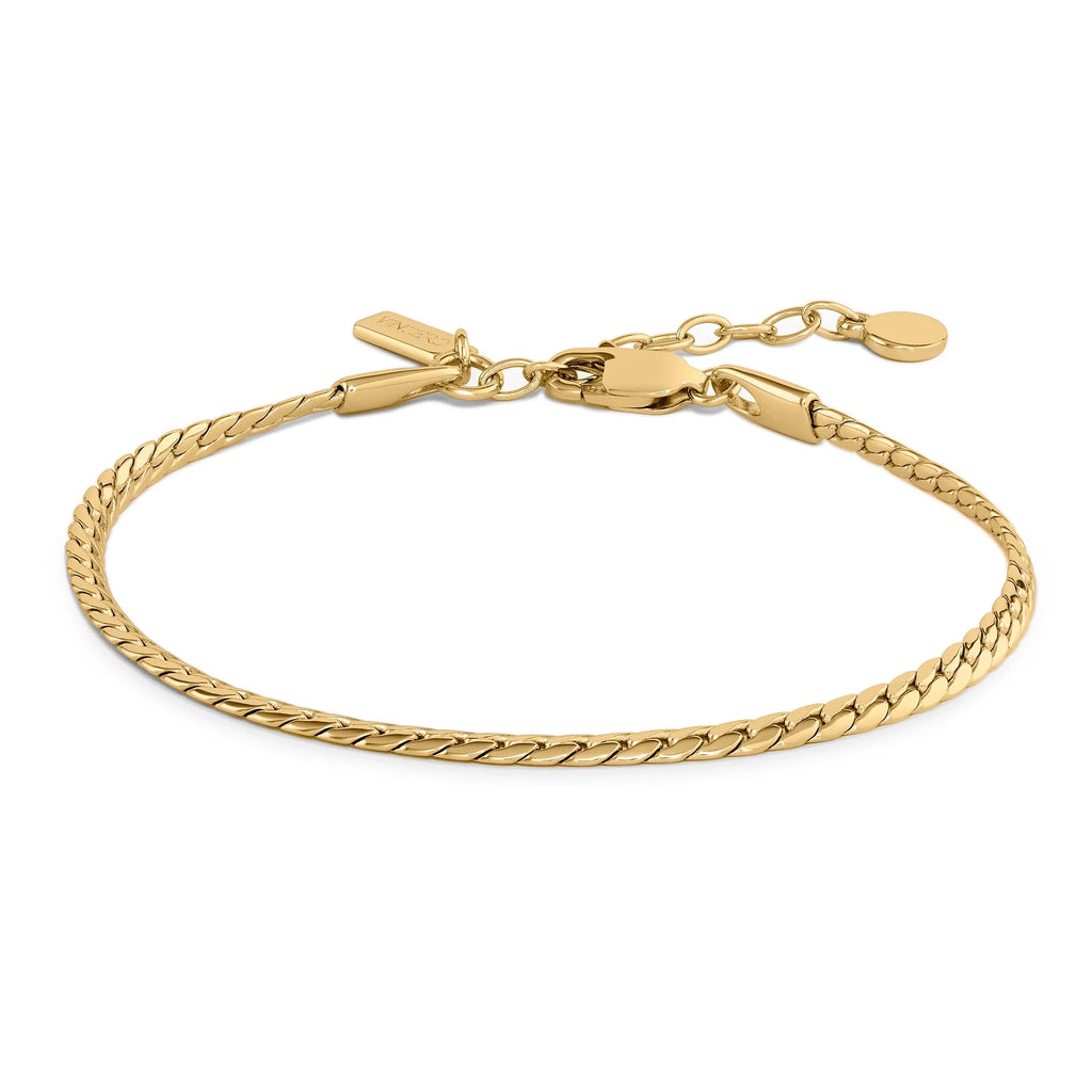 The Serpentine Bracelet in gold tone featuring a sleek, flat braided chain design.