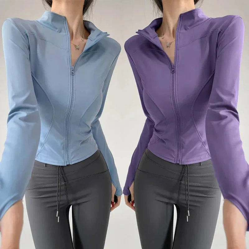 Model wearing a sleek zip-up sports jacket in light blue and purple, paired with activewear leggings.