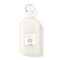 Guerlain Shalimar Sensational Body Lotion in a creamy white bottle with gold accents.