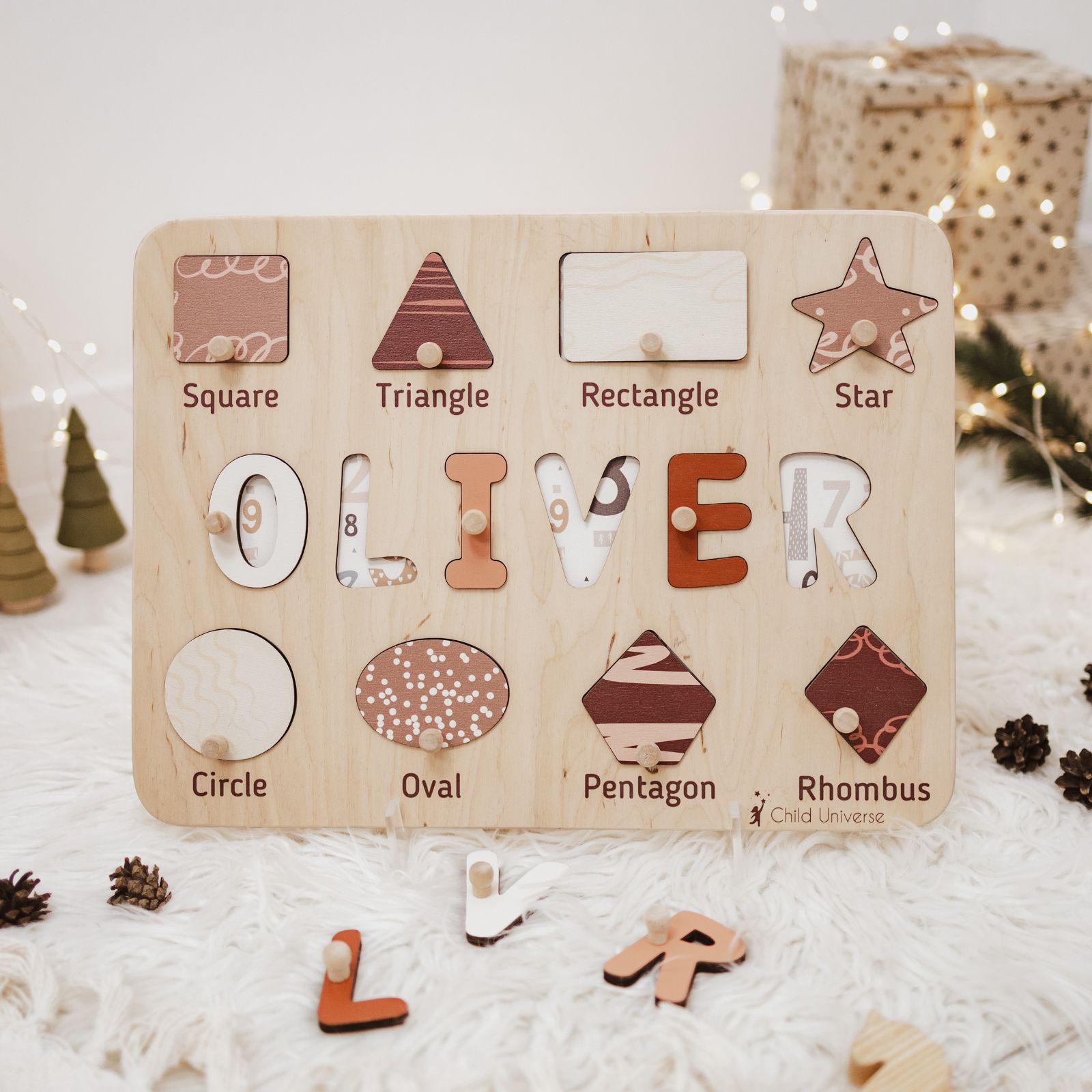 Wooden personalized name puzzle board featuring geometric shapes in beige, terracotta, and brown on a neutral background.