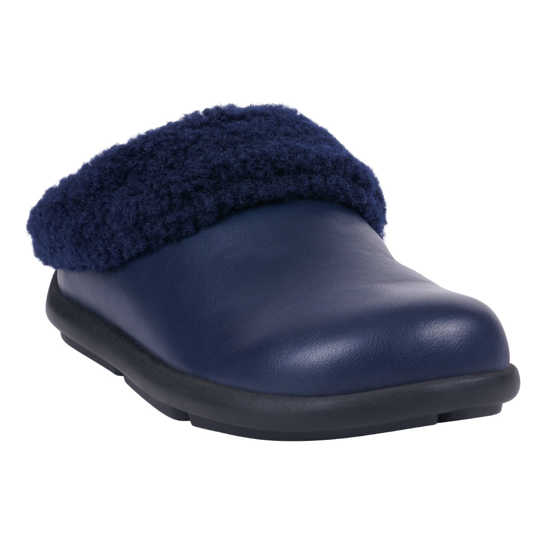 Women's navy blue Shari mule slipper with faux leather upper and plush shearling-style collar, viewed from a side angle.