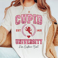 Person wearing a white t-shirt with 'Cupid University' design and text.