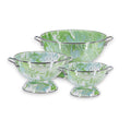 Set of three Golden Rabbit Modern Monet enamelware colanders in varying sizes on a kitchen counter