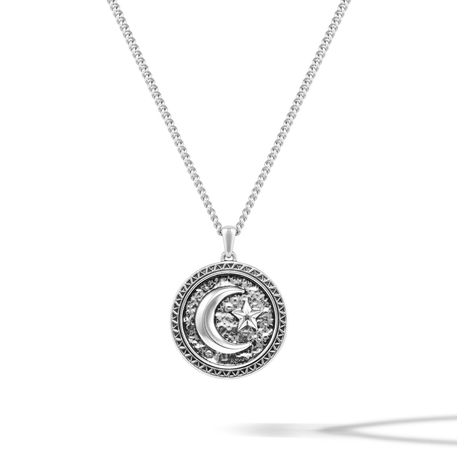 Close up of a Star & Crescent Amulet pendant made of polished sterling silver.