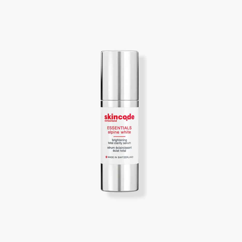 Skincode Alpine White Brightening Total Clarity Serum bottle in white and silver.