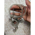 Silver-tone bohemian bangles featuring mirror work and dangling jhumka charms.