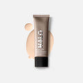 Smashbox Halo Healthy Glow All-In-One Tinted Moisturizer SPF 25 in a neutral beige tube.