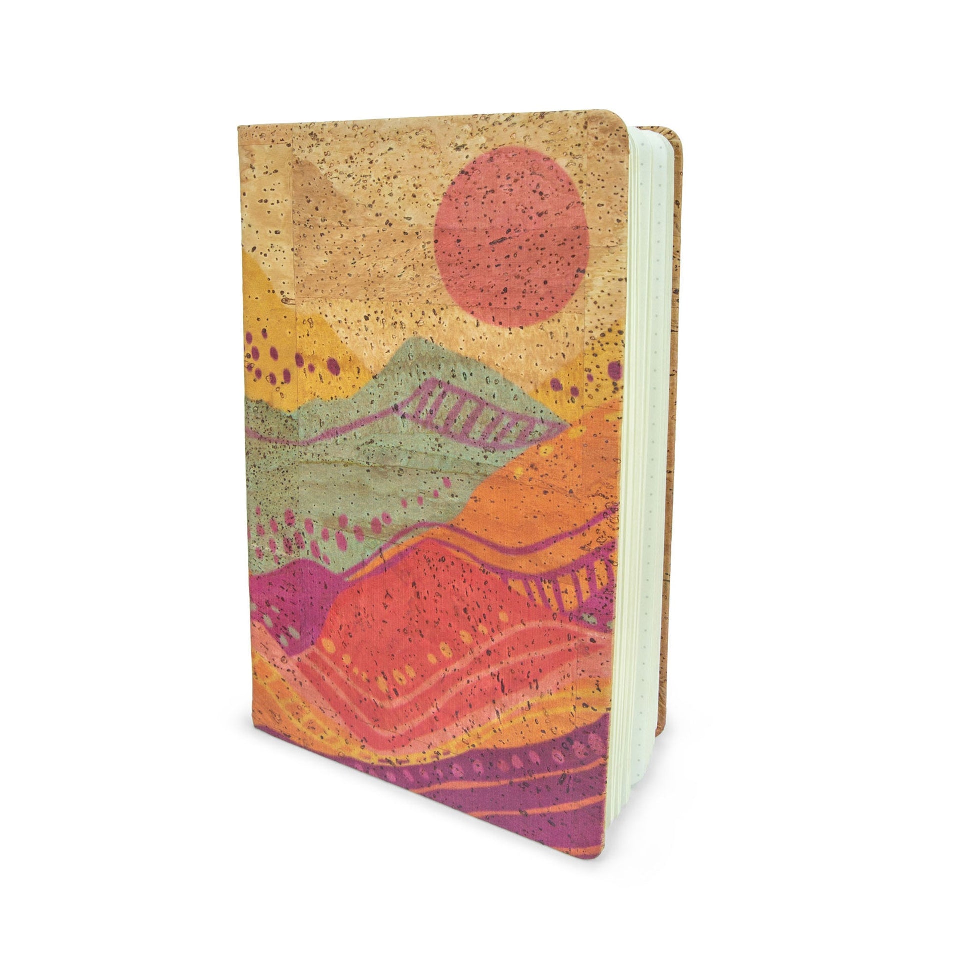 A5 Spirit Rising cork-wrapped journal in a desert sunset palette, styled in a bohemian home office setting.