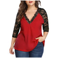 A woman wearing a V-neck blouse with black lace sleeves, available in red and pink
