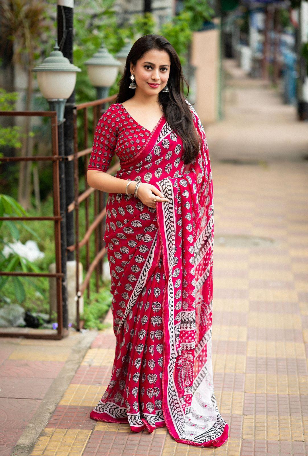 Rani colored poly georgette Ajrak saree with aari mirror work and piping border