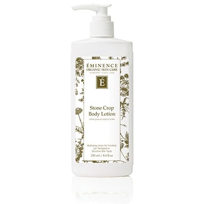 Bottle of Eminence Stone Crop Body Lotion in white and green packaging