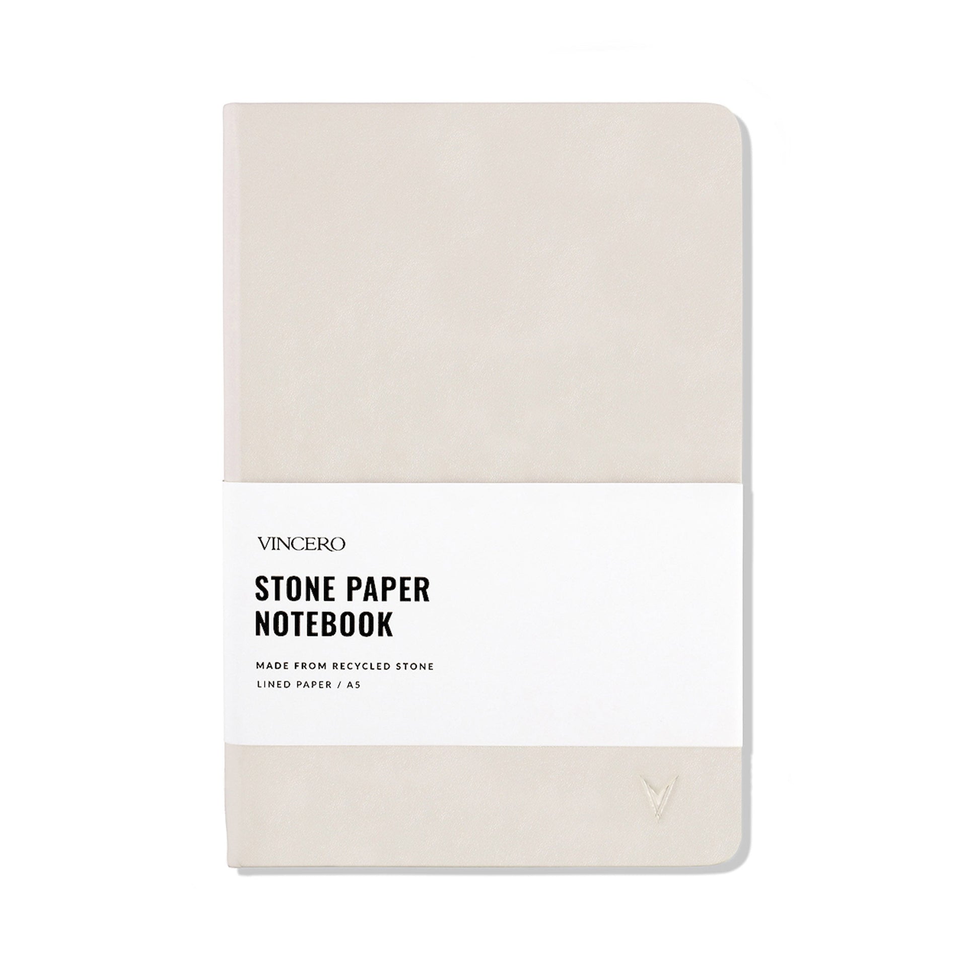 Close up of a Bone colored hardcover stone paper notebook with an elastic band and ribbon bookmark.