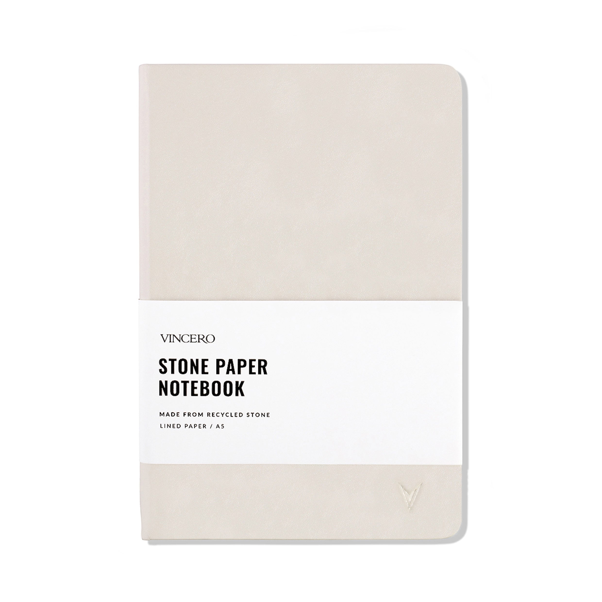 Close up of a Bone colored hardcover stone paper notebook with an elastic band and ribbon bookmark.