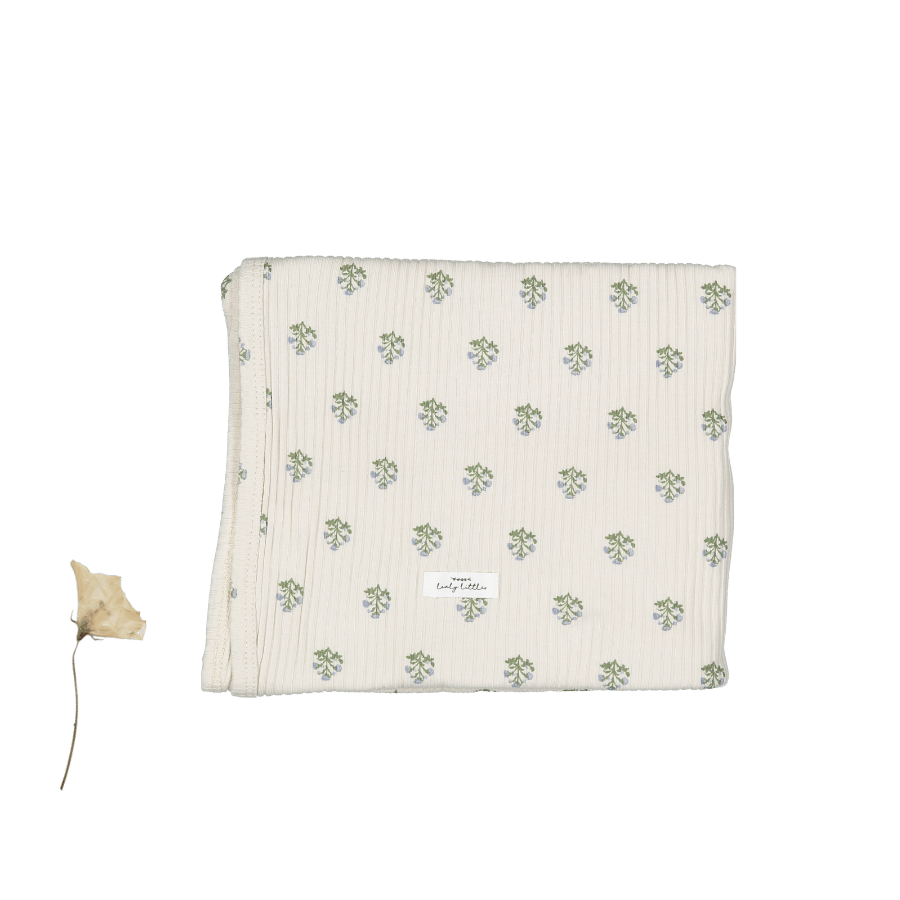 Folded soft cotton swaddle blanket in cream with Zara Blue small floral print pattern