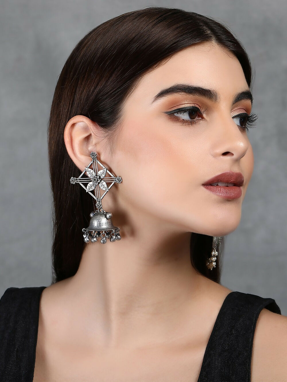 Elegant silver tone brass jhumka earrings with ghungroo details and sparkling stones