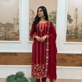 A three-piece red velvet kurta set with intricate embroidery and sequence work details.