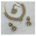 Exquisite cream-colored stone work necklace set including matching earrings and tikka for formal occasions