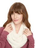 A woman wearing a soft cream-colored fuzzy knit infinity scarf, styled for a cozy minimalist winter look.