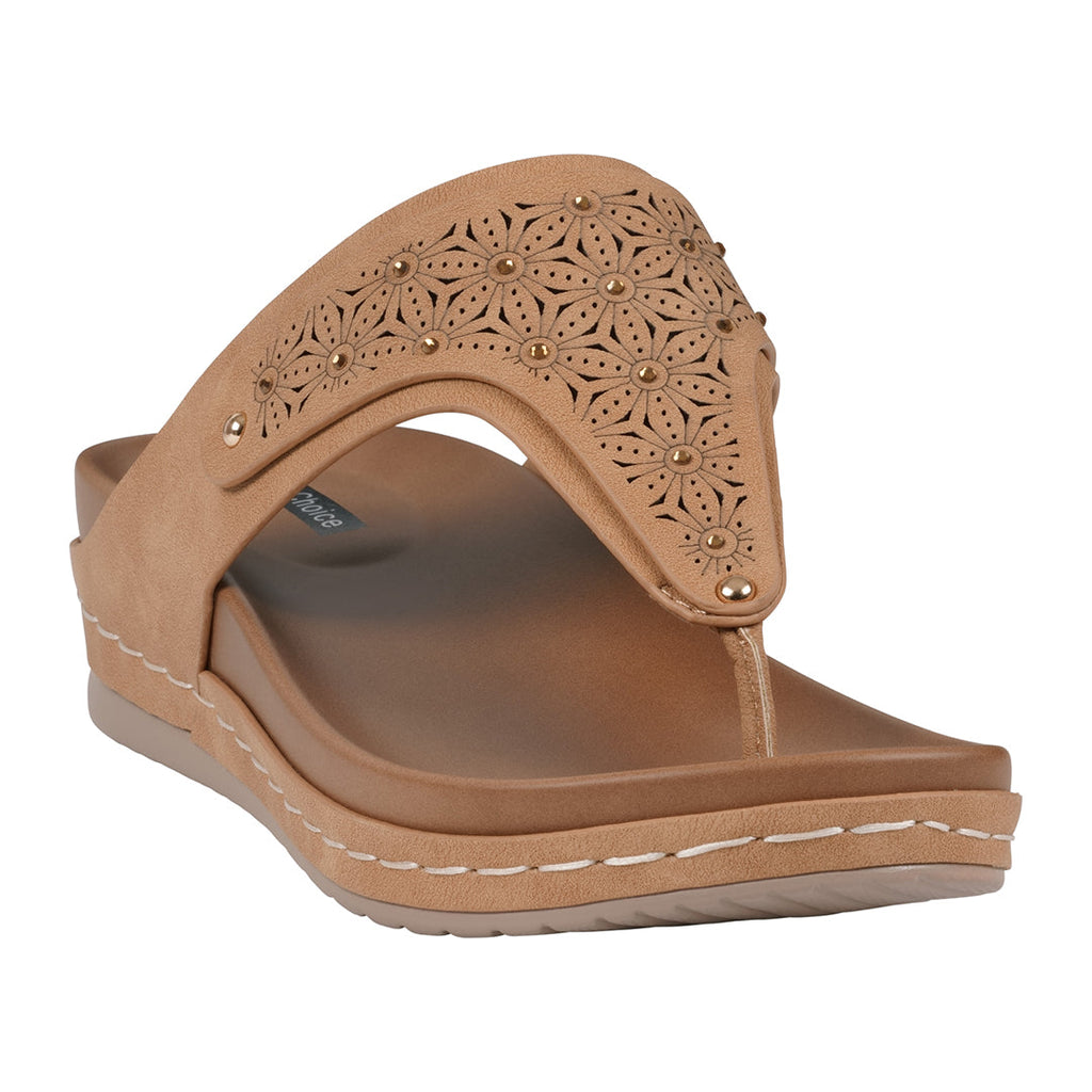 Tan laser-cut thong wedge sandals with floral pattern and metallic studs