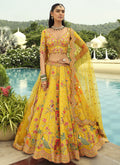 Yellow silk lehenga choli with heavy embroidery and art mirror work border