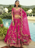 Rani Pink silk lehenga choli with intricate embroidery and art mirror work for wedding wear