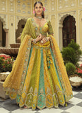 Front view of a yellow silk lehenga choli with heavy embroidery and mirror work details