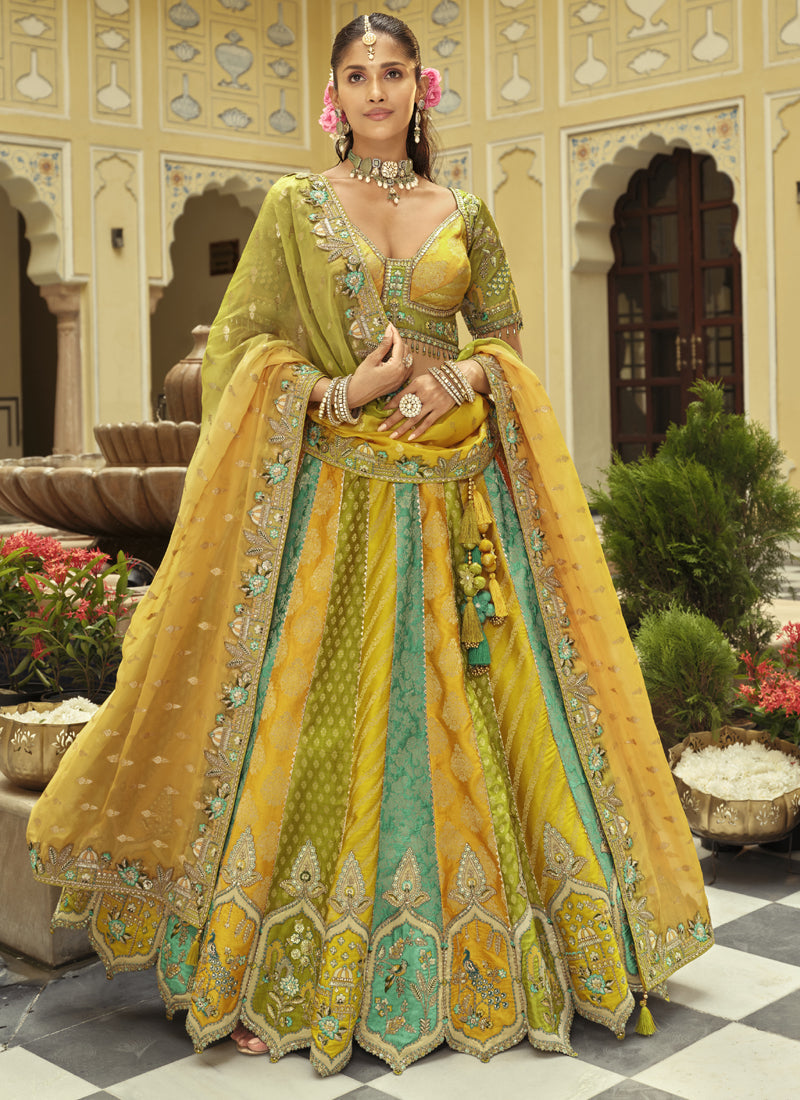 Front view of a yellow silk lehenga choli with heavy embroidery and mirror work details