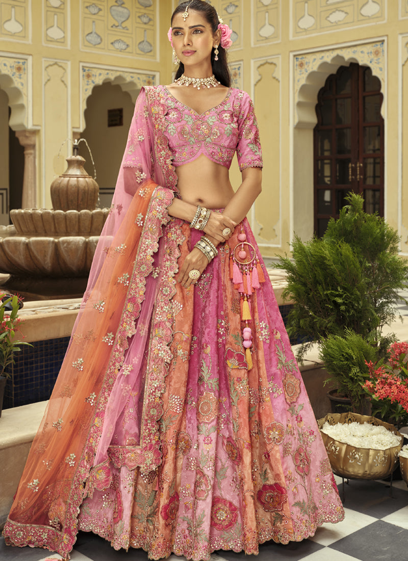 Peach silk lehenga choli with heavy embroidery and art mirror work detail