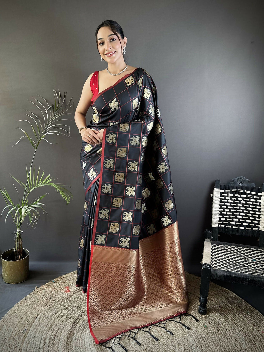 Black soft silk Banarasi saree with elephant motifs and pink blouse