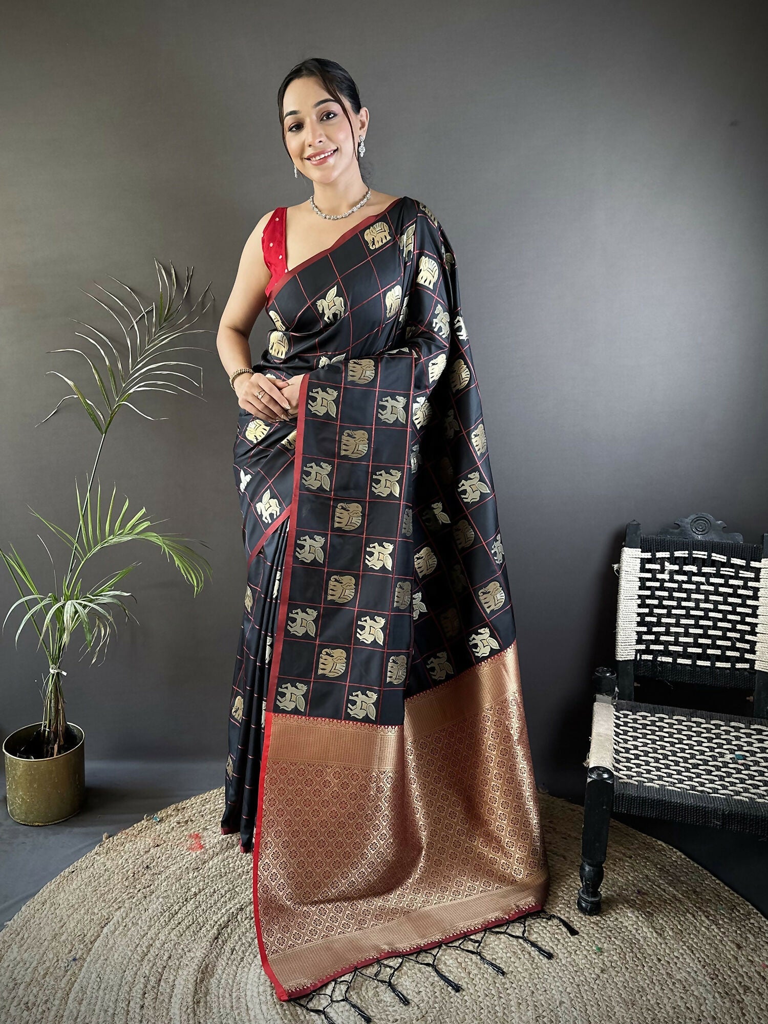 Black soft silk Banarasi saree with elephant motifs and pink blouse