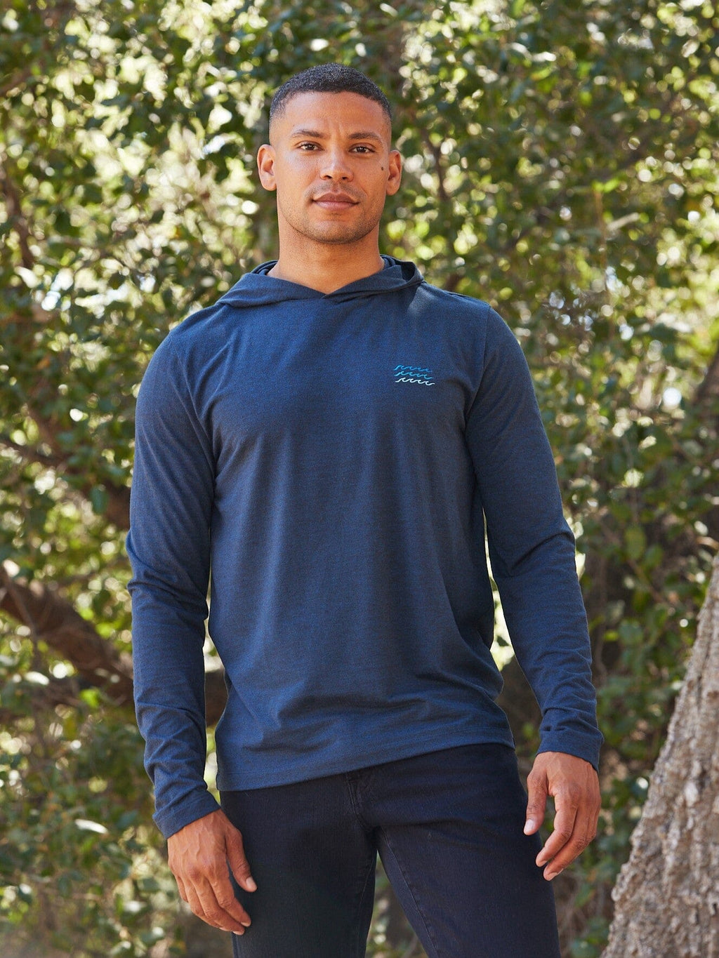 Men's navy blue long sleeve hoodie tee with embroidery detail on the chest.